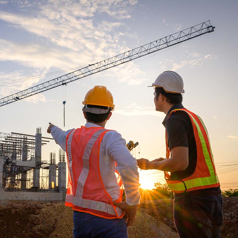 Construction workers looking at a building site