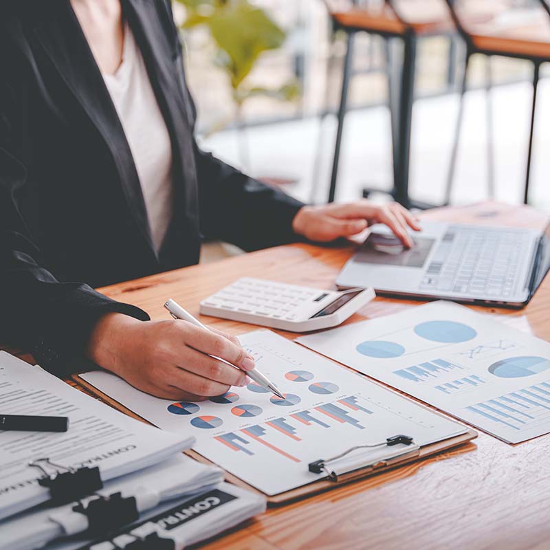 Accountant with charts and calculator sitting at a desk